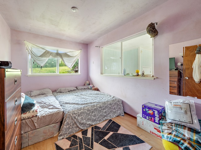 bedroom with light wood-type flooring