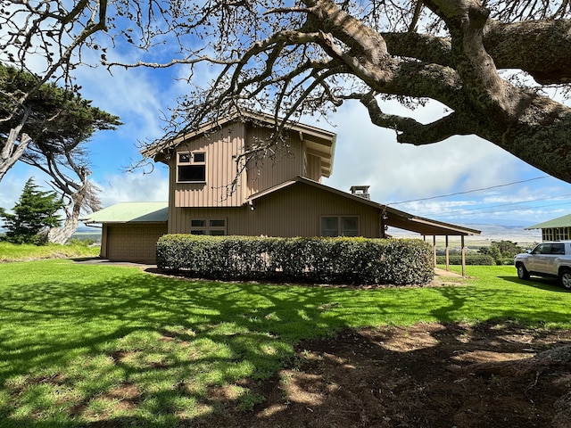 view of side of home with a yard