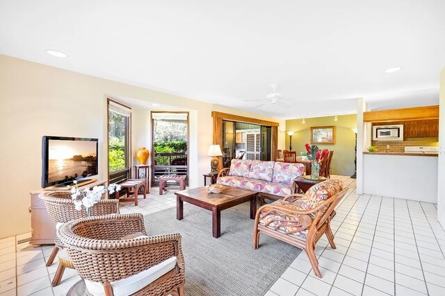 tiled living room featuring ceiling fan