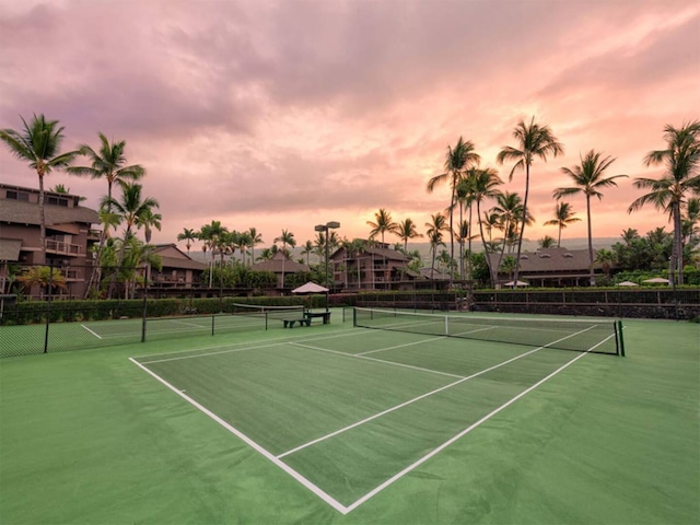 view of tennis court featuring fence