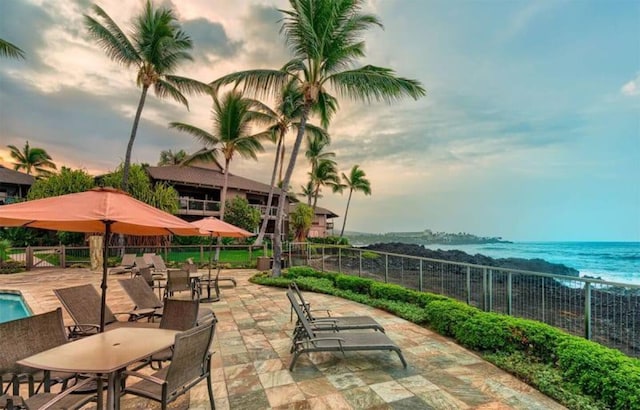 patio terrace at dusk with a water view and fence