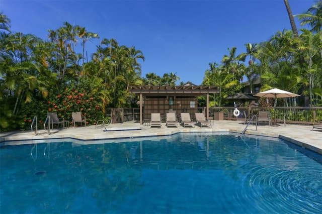 pool with fence and a patio