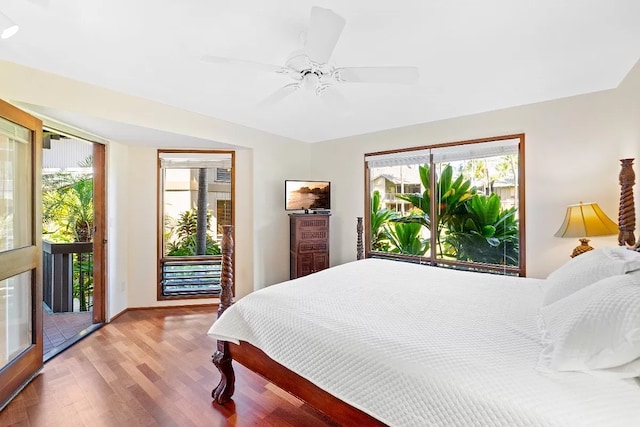 bedroom featuring ceiling fan, access to outside, and wood-type flooring