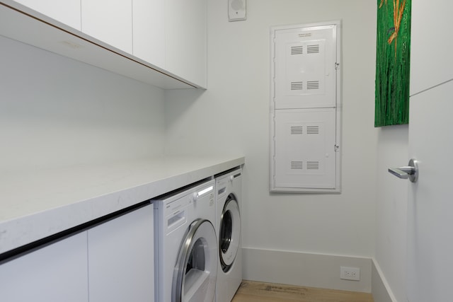 washroom with cabinets and washer and clothes dryer