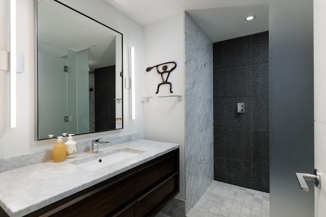 bathroom featuring vanity and a tile shower