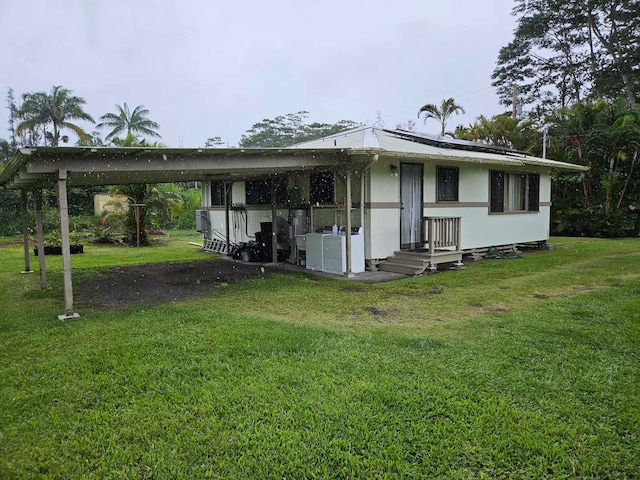 back of property featuring a yard