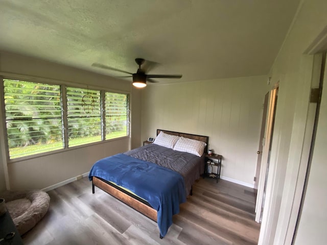 bedroom with ceiling fan and hardwood / wood-style floors