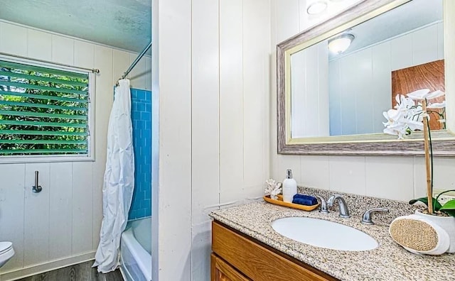 full bathroom with wood-type flooring, oversized vanity, toilet, and shower / bath combo