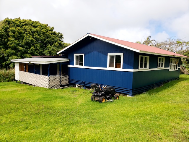 back of property featuring a lawn