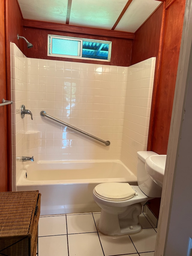 bathroom with tile flooring, washtub / shower combination, and toilet