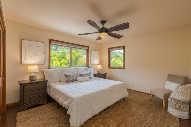 bedroom with ceiling fan and dark wood-type flooring