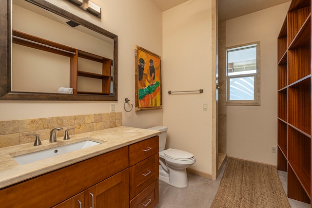 bathroom featuring backsplash, vanity, and toilet