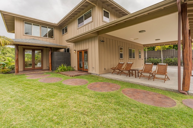 back of house with a patio, french doors, and a yard