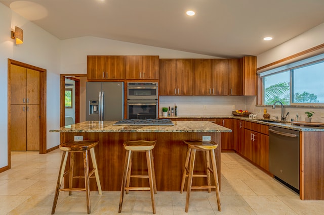 kitchen featuring tasteful backsplash, a kitchen island, light tile floors, and stainless steel appliances