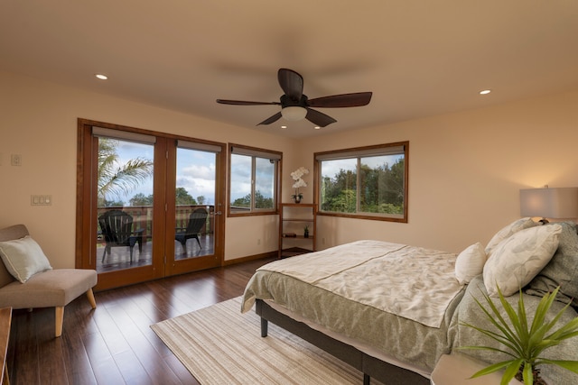 bedroom featuring dark hardwood / wood-style floors, ceiling fan, access to exterior, and multiple windows