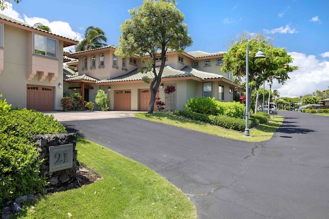 mediterranean / spanish home with a garage