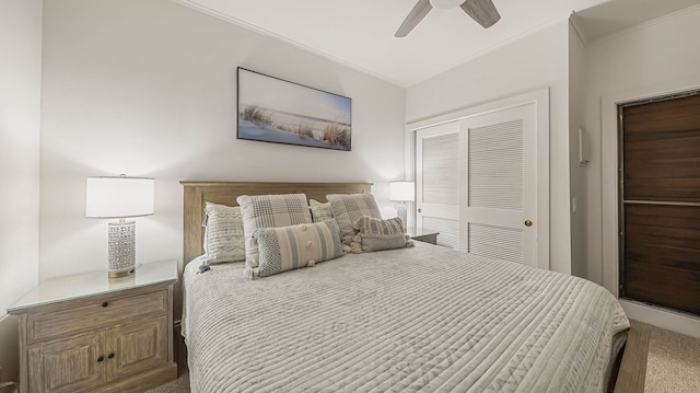 carpeted bedroom featuring ceiling fan and a closet