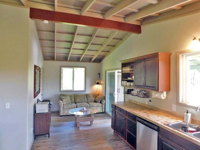 kitchen featuring dark brown cabinets, light hardwood / wood-style floors, stainless steel dishwasher, lofted ceiling with beams, and sink