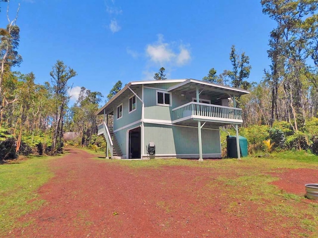 rear view of property with a balcony