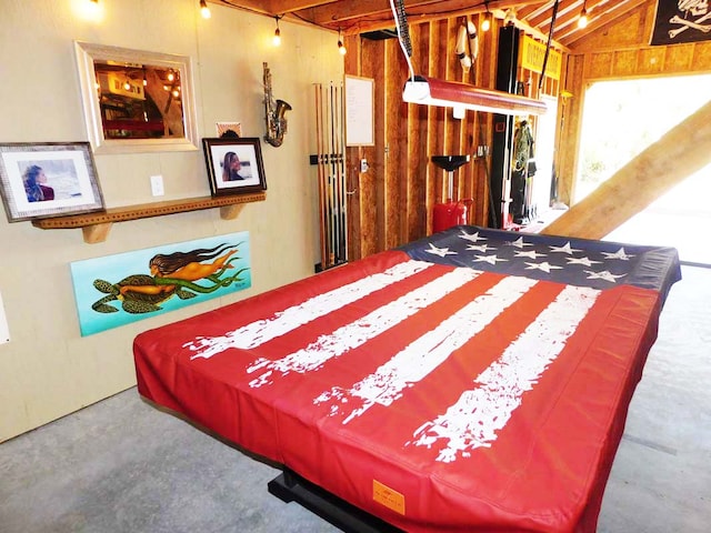 bedroom featuring billiards, concrete floors, and vaulted ceiling