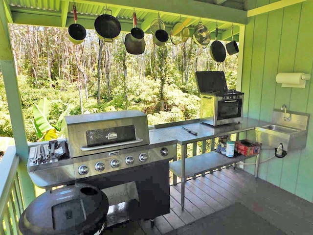 wooden terrace with a grill