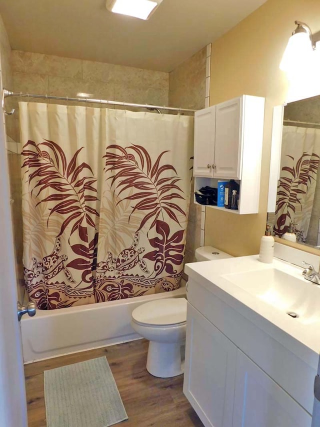 full bathroom featuring shower / bathtub combination with curtain, vanity, toilet, and hardwood / wood-style floors