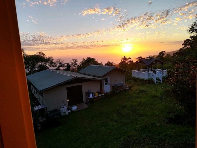 property exterior at dusk with a yard