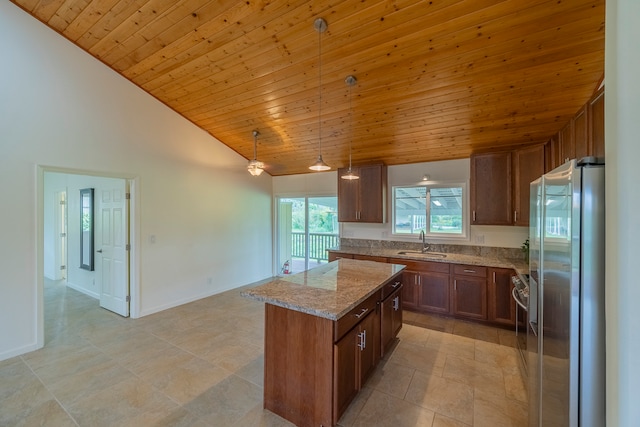 kitchen with pendant lighting, stainless steel fridge, wood ceiling, and light tile floors