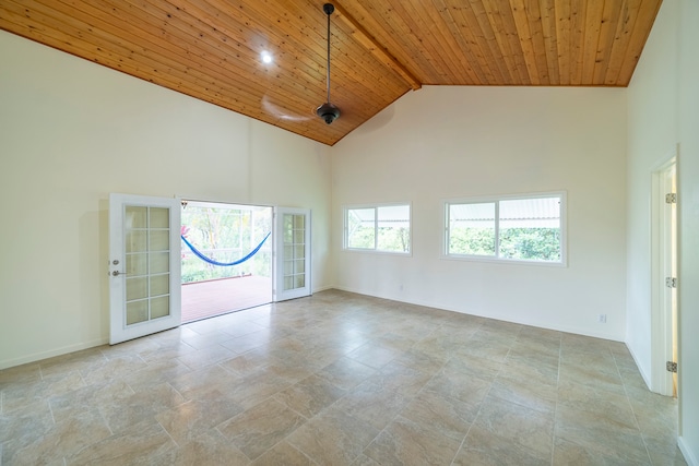 tiled empty room featuring wooden ceiling, french doors, and high vaulted ceiling