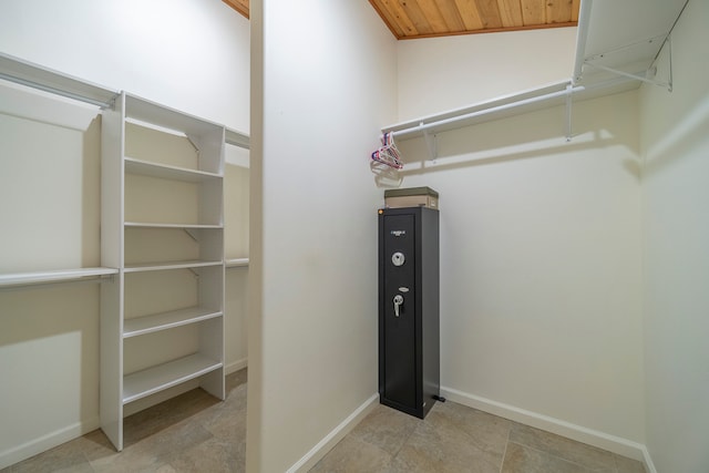 spacious closet featuring lofted ceiling and light tile floors