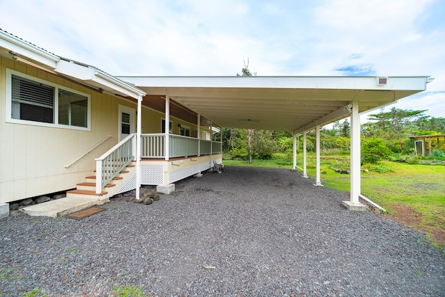 exterior space with a carport and a yard