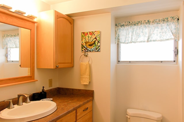 bathroom featuring toilet and vanity