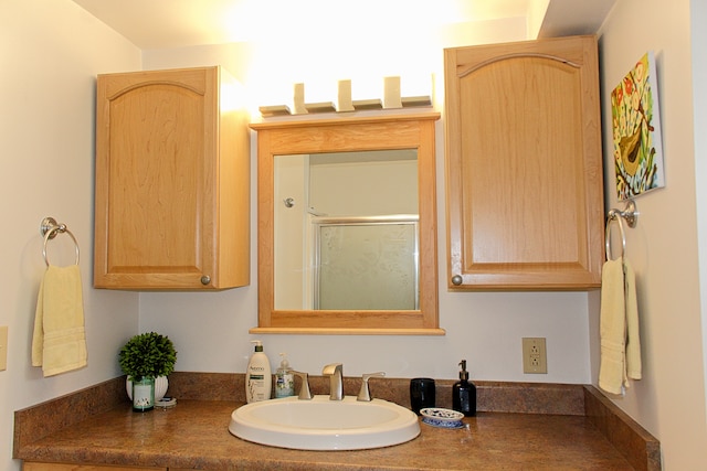 bathroom with walk in shower and vanity