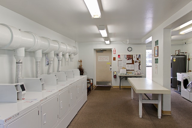 washroom with washer and dryer, dark carpet, and strapped water heater