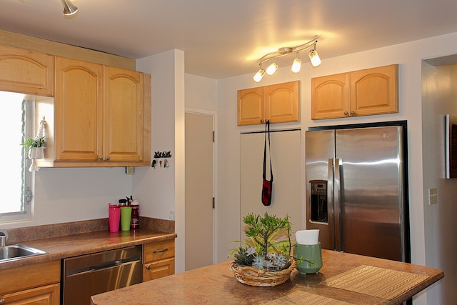 kitchen featuring stainless steel appliances, light brown cabinets, and sink