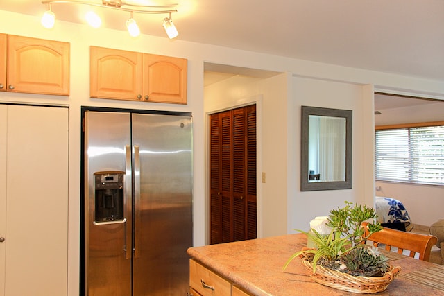 kitchen featuring stainless steel refrigerator with ice dispenser and light brown cabinets