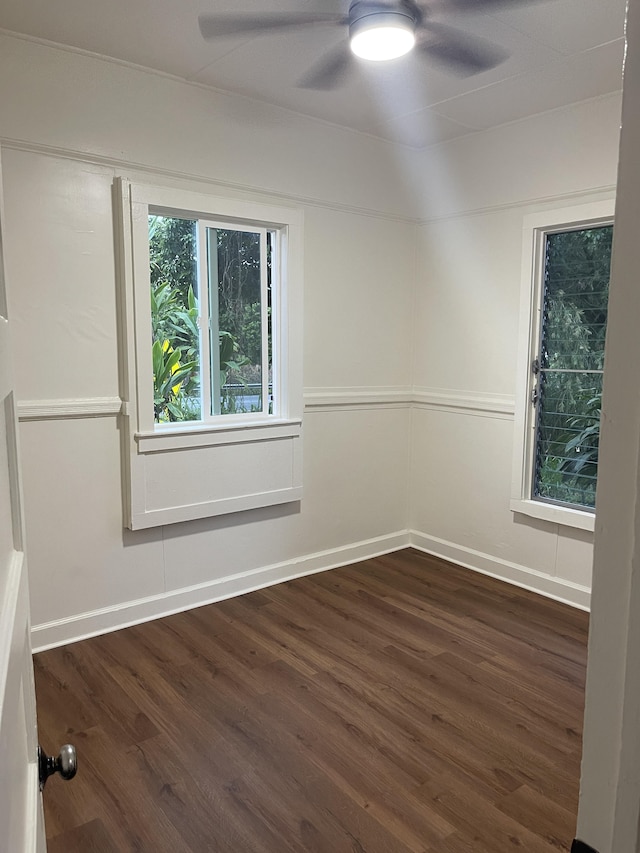 empty room featuring ceiling fan, baseboards, and wood finished floors