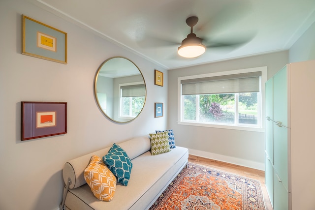 interior space featuring ceiling fan, light hardwood / wood-style flooring, and ornamental molding