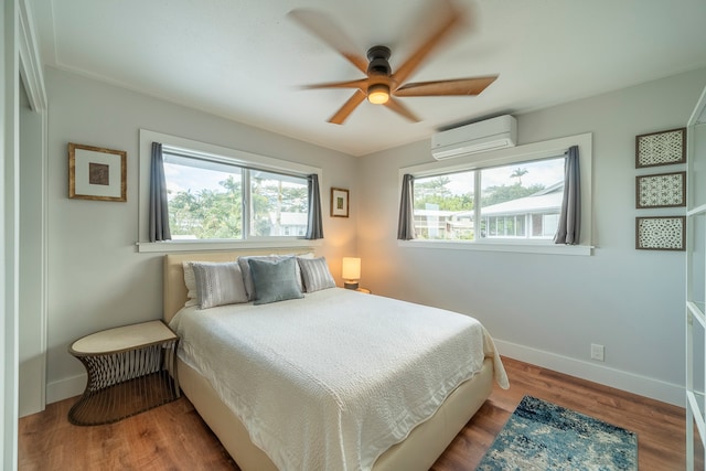 bedroom with hardwood / wood-style floors, ceiling fan, and a wall mounted air conditioner