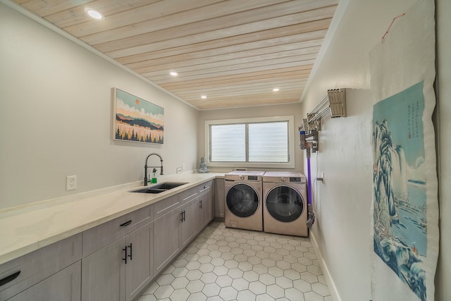 laundry room with washer and dryer, light tile floors, sink, cabinets, and wooden ceiling