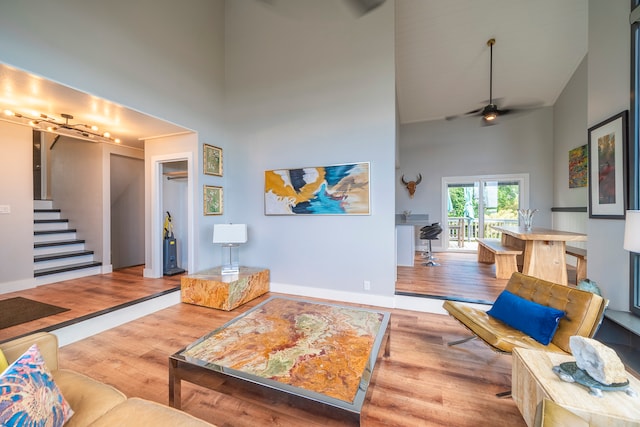 living room with high vaulted ceiling, wood-type flooring, and ceiling fan