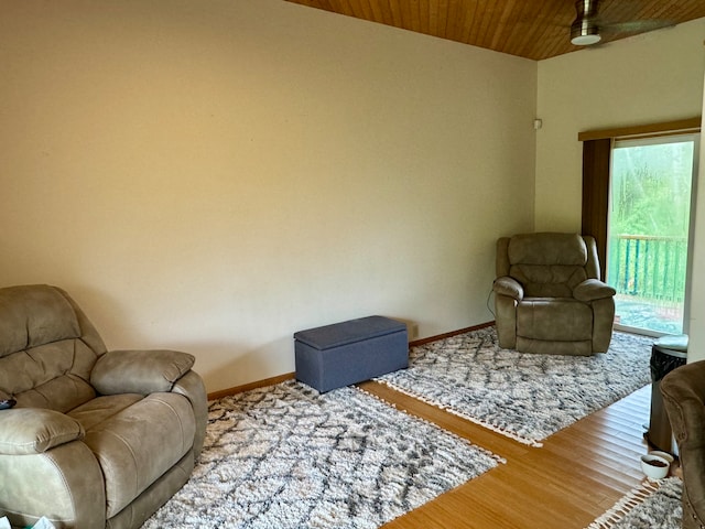 living room featuring ceiling fan, hardwood / wood-style flooring, and wood ceiling