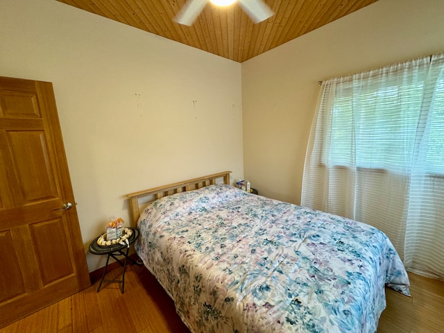 bedroom with ceiling fan, hardwood / wood-style floors, and wood ceiling