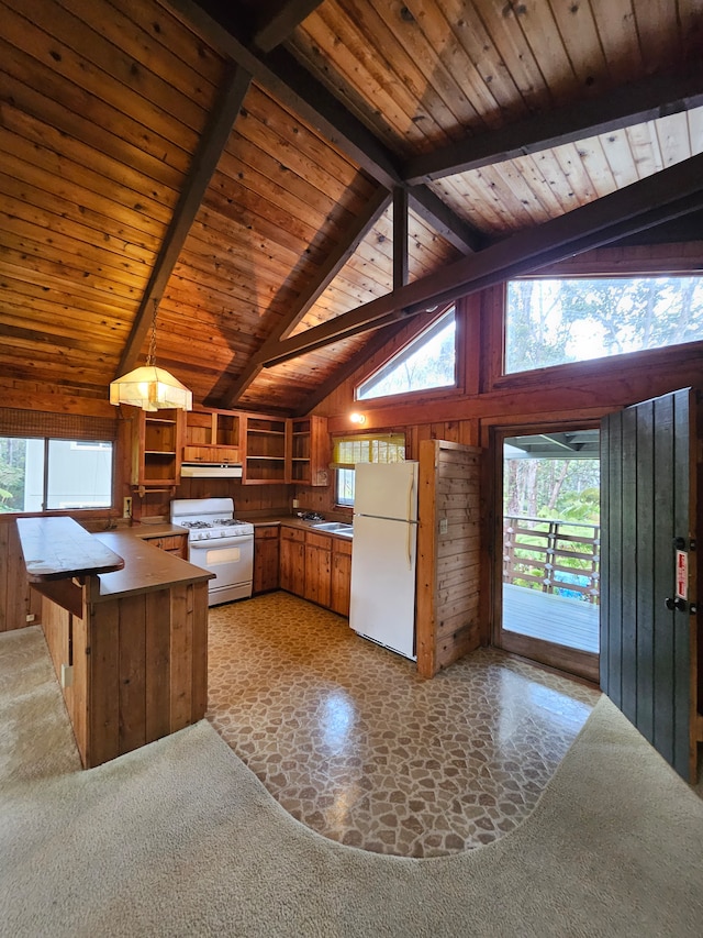 kitchen with wooden walls and vaulted ceiling with beams