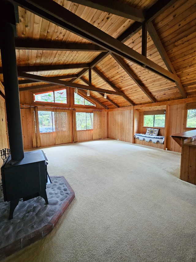 stairs featuring high vaulted ceiling, plenty of natural light, and wood walls