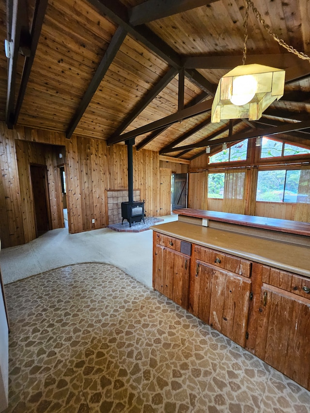 stairs featuring vaulted ceiling, wood walls, and wooden ceiling