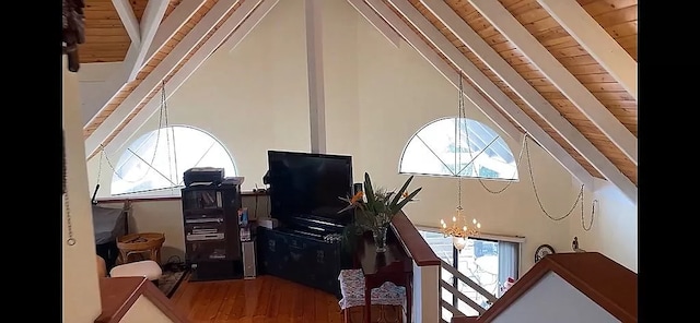 office space with a chandelier, hardwood / wood-style flooring, a towering ceiling, and wooden ceiling