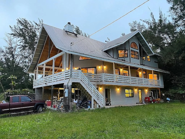 rear view of property featuring a lawn