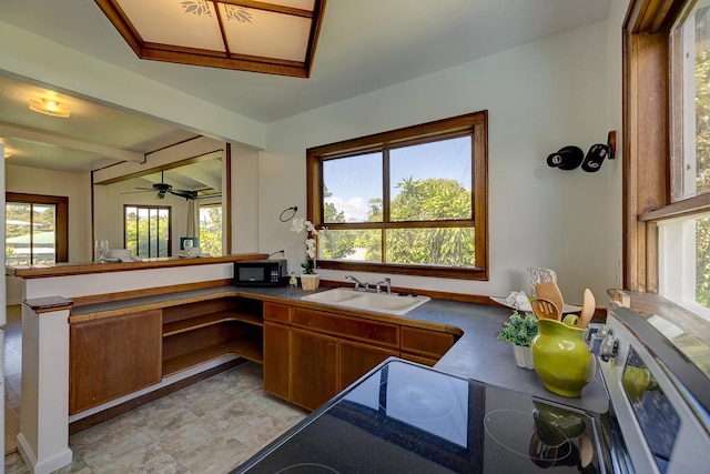 kitchen featuring ceiling fan and sink