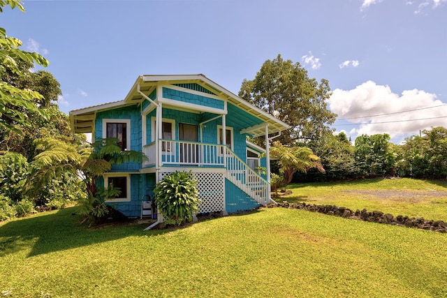 view of front facade with a front yard and covered porch